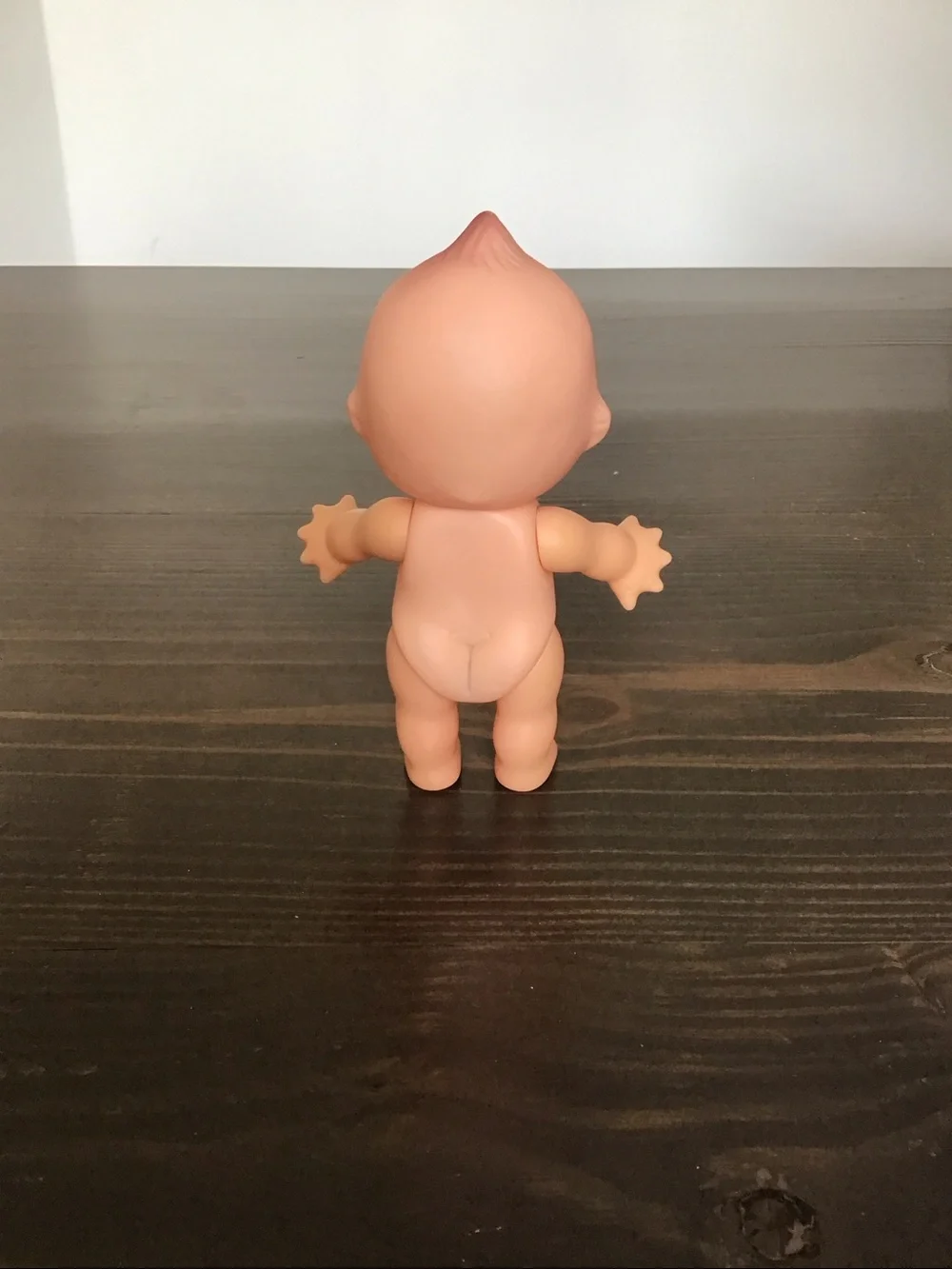 Vintage unmarked 6-inch hard plastic Kewpie doll from the mid-century era